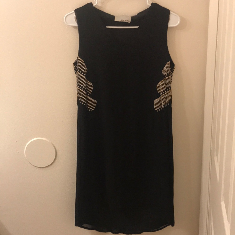 Black cocktail dress with cool detail.
